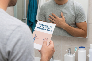 Uomo che verifica i sintomi di ingrossamento e dolore alla ghiandola mammaria, indicando una possibile ginecomastia o mastite.
